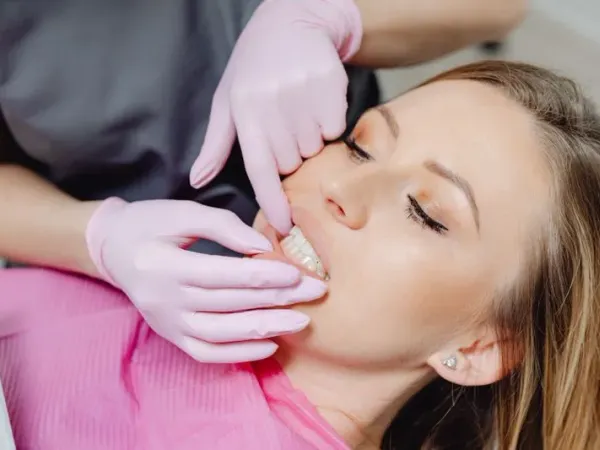 Dental professional fitting custom dentures for a patient