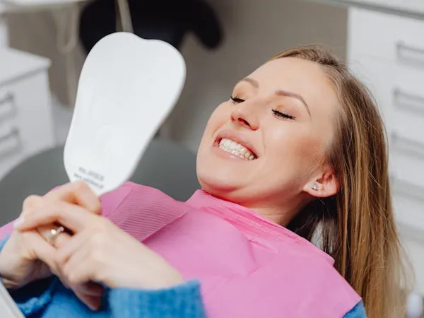 Patient admiring her smile after treatment